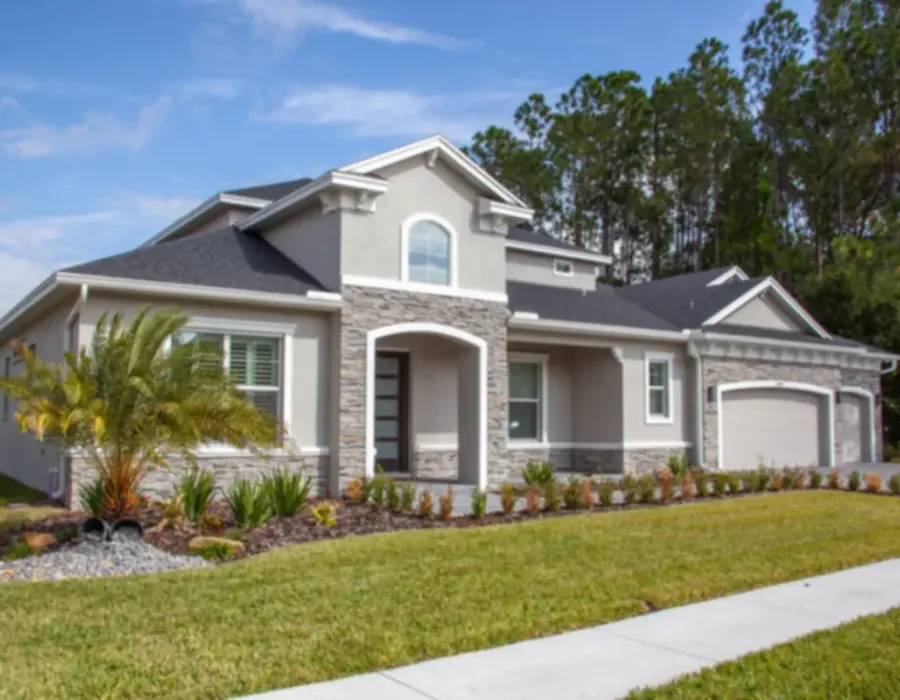 A single-story Florida home with stone accents and mature landscaping