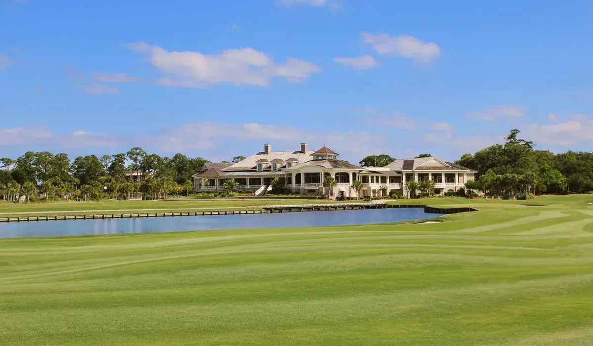 Clubhouse and golf course beside a lake in a gated Florida golf community